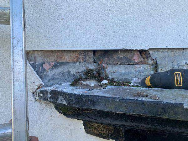 Moss and broken render where the bay roof met the wall