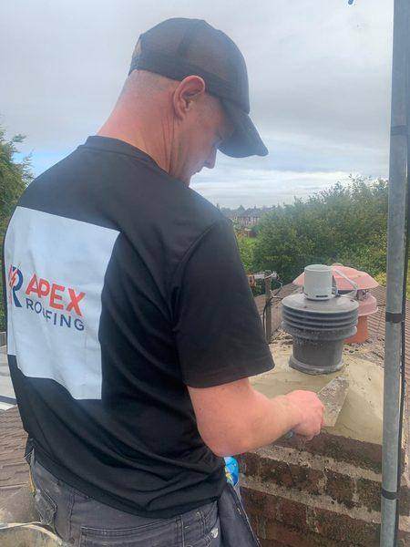 Working the new mortar off against the top course of brick