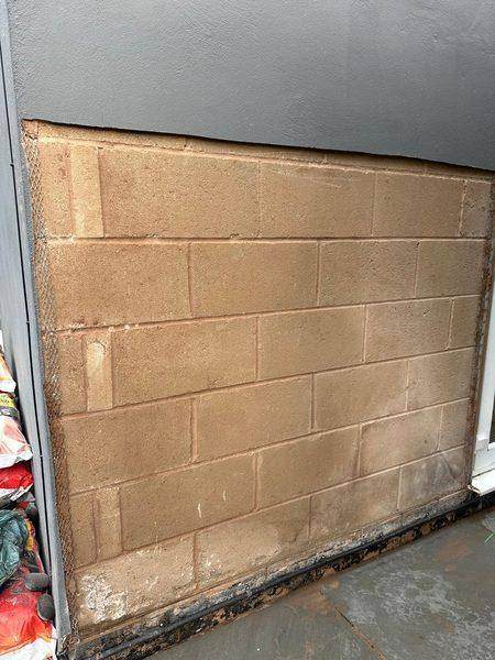 Blown render taken off back to the blockwork on the damp wall