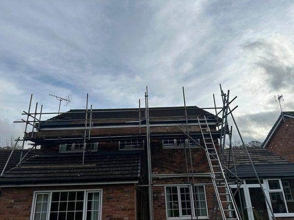 Scaffold up across the elevation, the roof area stripped ready for felting