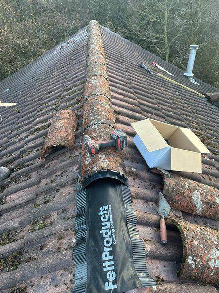 The roll dressed down over the tile courses, kit box open alongside