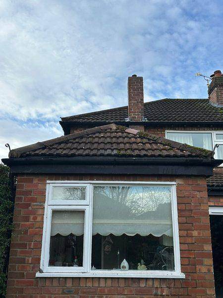 The kitchen roof before work, moss across the old interlocking tiles