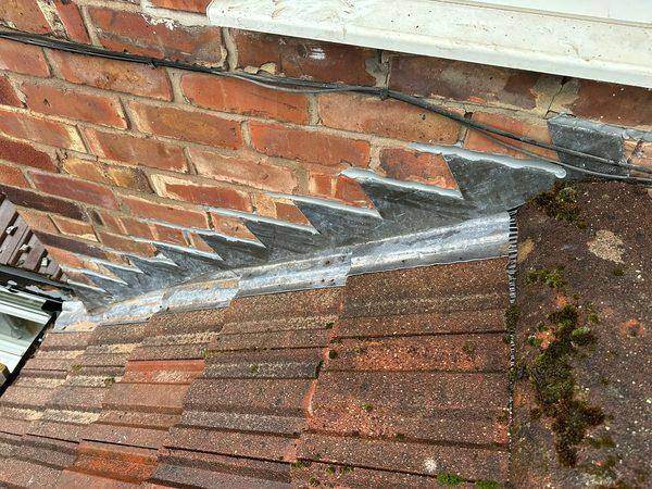 Close up of the old stepped lead, moss grown right up to the brickwork