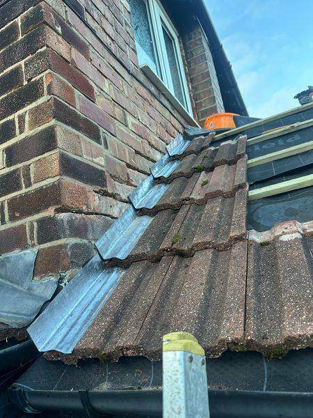 The renewed lead stepped down the brickwork and dressed over the tiles