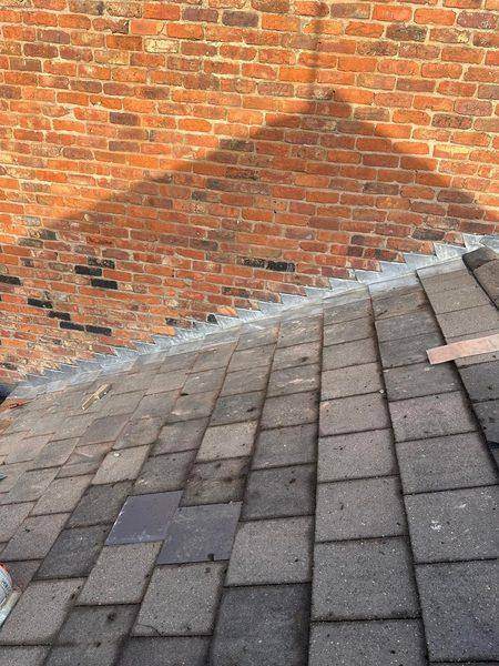 Stepped lead worked into the brick joints above the finished tile courses