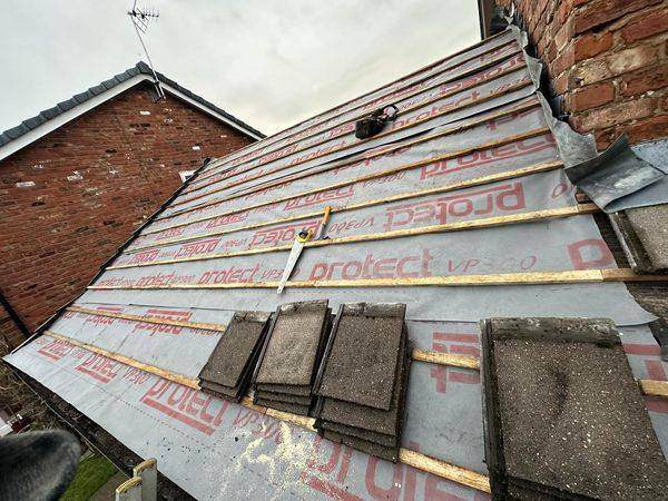 Breathable underlay down and battens fixed, tiles stacked ready to go back