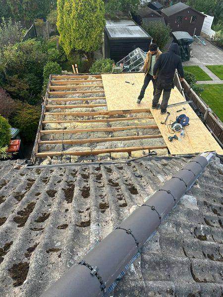Boarding out across the joists, the old insulation still in place