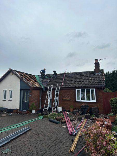 The front slope open to the rafters while the far end still carries its tiles