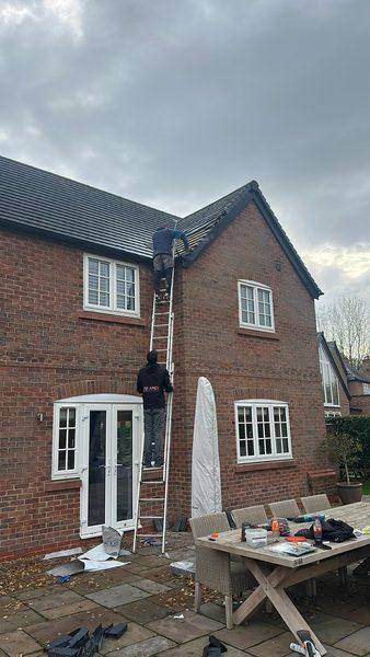 Working at the verge from the ladder, tools laid out below