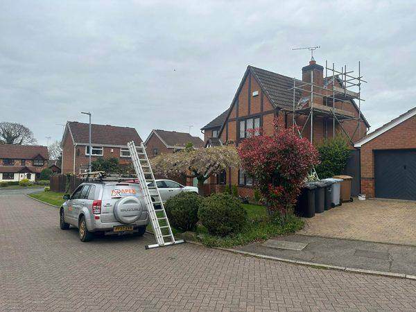 Scaffold up at the gable end with the van on the drive