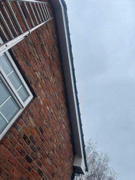 New white UPVC fascia and soffit running the length of the brick gable