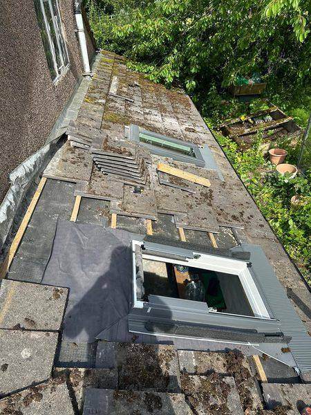 Looking along the roof: one window done, one going in